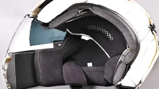 A helmet showing water damage and degradation to the interior foam and padding